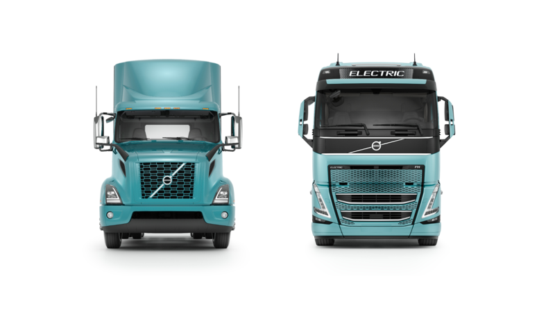 Picture of Two green Volvo trucks against a white background 